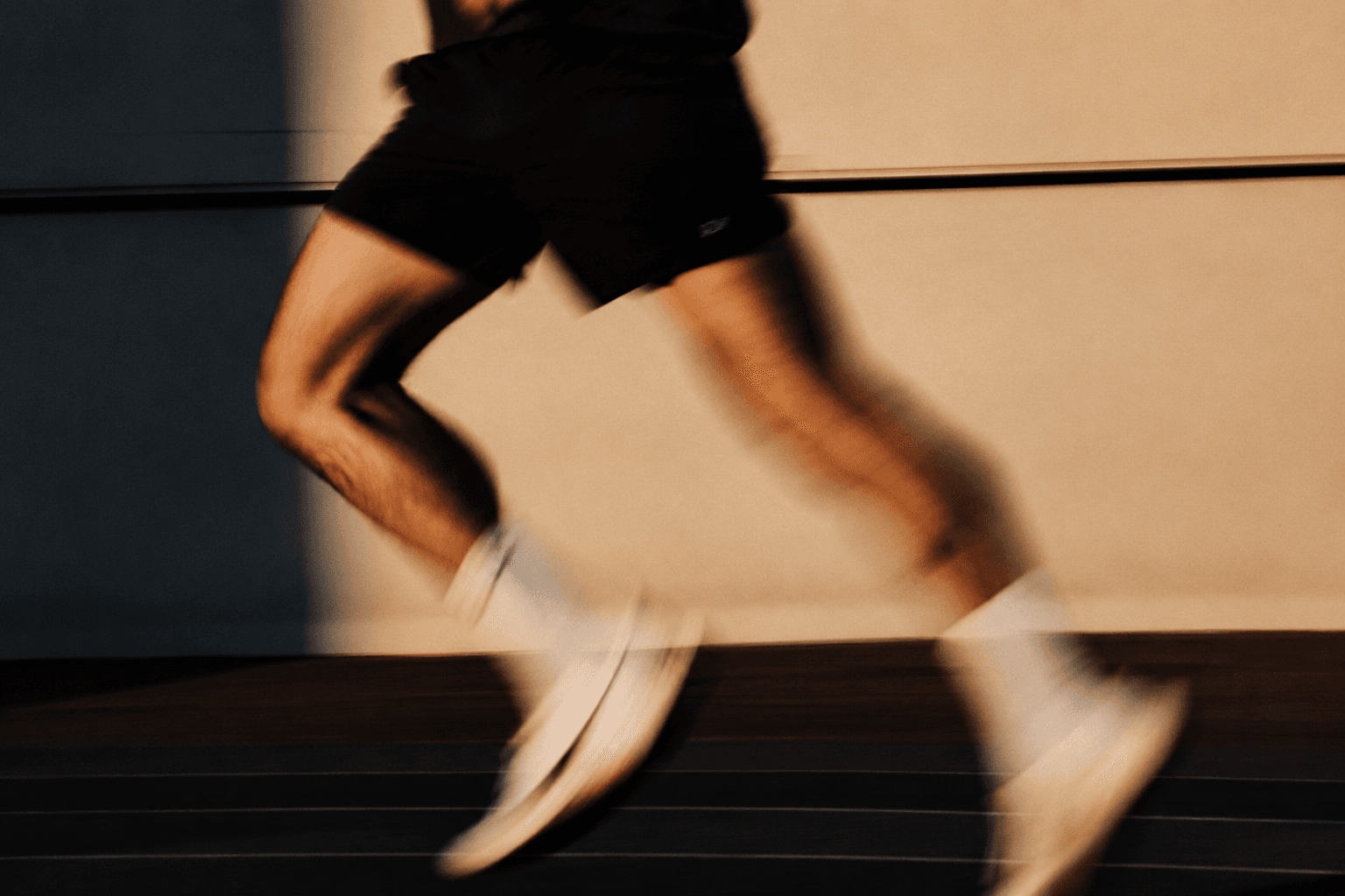 An athlete mid-stride on a running track